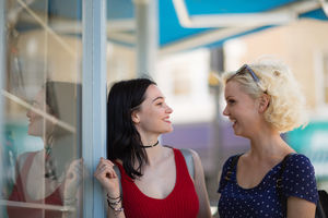 Female friends window shopping in summer