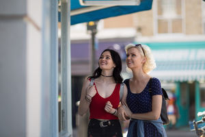 Female friends window shopping in summer