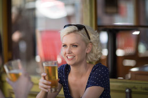 Female friends drinking beer in summer outdoors
