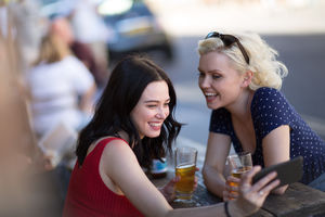 Tourists taking a selfie in a London Pub