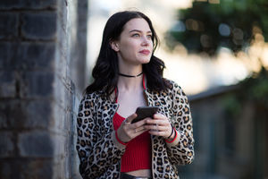 Young adult female using smartphone on street