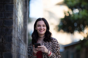 Young adult female using smartphone on street