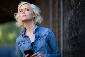 Young adult female using smartphone on street