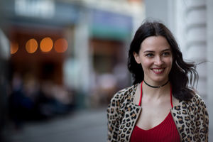 Young adult female walking down street in the evening