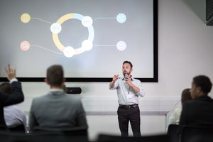 Speaker at a business training conference taking a question