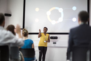 Speaker at a business training conference taking a question