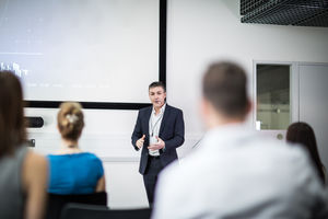 Speaker at a business training conference taking a question