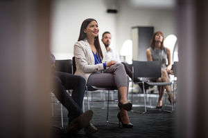 Female executive listening at a business conference