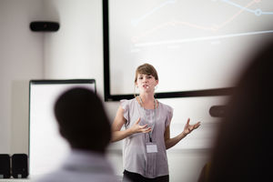 Young female executive speaking at a conference