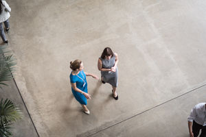 Overhead shot of a two businesswomen walking through an office