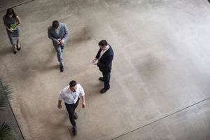 Overhead shot of busy office lobby, atrium, reception