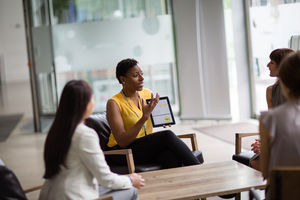 Businesswoman in a meeting using a digital tablet
