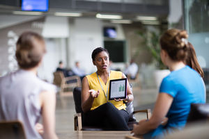 Businesswoman in a meeting using a digital tablet