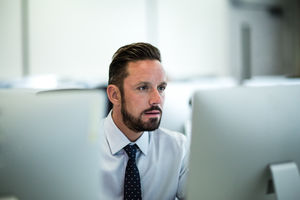 Businessman using computer in empty office