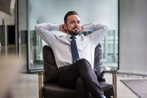 Successful businessman leaning back in chair 