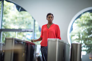 Woman walking through security gates in an office