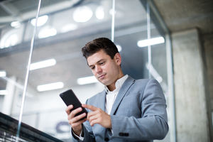 Businessman using smartphone in an office
