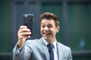Smiling man on video call outdoors