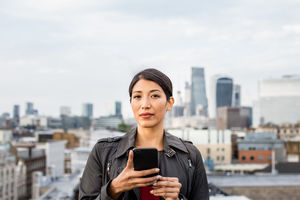 Portrait of businesswoman with London city skyline