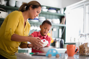 Mum helping son with breakfast
