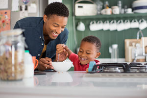 Boy happily eating breakfast
