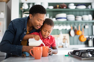 Dad teaching son to make a cup of tea on Mothers Day