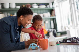 Dad teaching son to make a cup of tea on Mothers Day