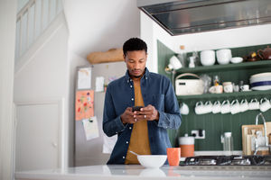 African American male checking phone in the morning