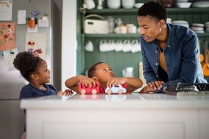 Brother and sister playing at breakfast time 