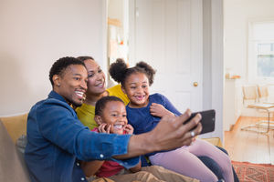 Family taking a selfie with a smartphone
