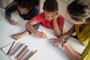 Children learning how to write alphabet