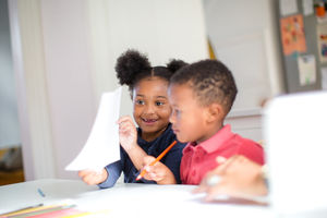 African American holding up school work proudly