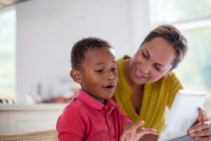 Boy playing on digital tablet
