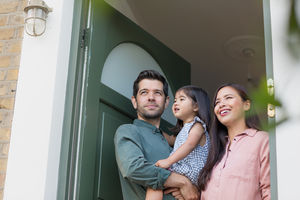 Family standing in doorway of home
