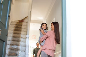 Mother carrying daughter home