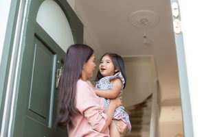 Mother carrying daughter home