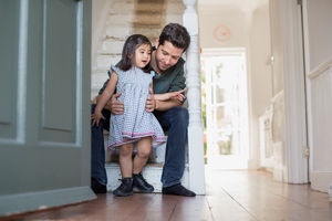Dad helping daughter walk