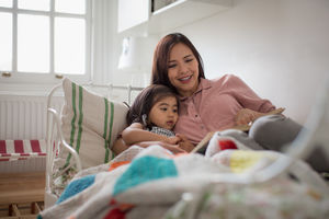 Mother reading Daughter a bedtime story