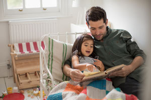 Father reading Daughter a bedtime story