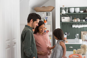 Pregnant mother with daughter and family