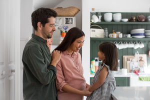 Pregnant mother with daughter and family