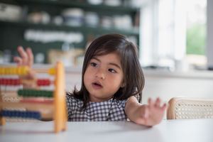Girl using abacus to count