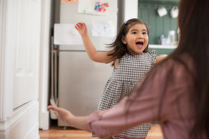 Girl running into mother’s arms