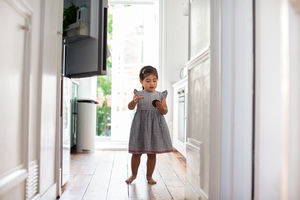 Girl taking a treat from a refrigerator