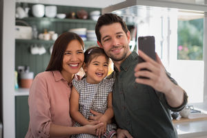 Family taking a selfie with a smartphone