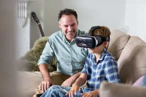 Boy using a VR headset game at home