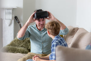 Father and Son using a virtual reality glasses at home
