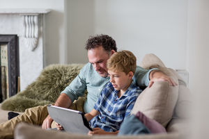 Father and Son looking at a digital tablet