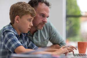 Father helping son with homework
