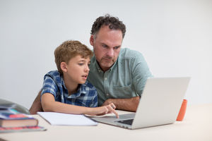 Father helping son with homework